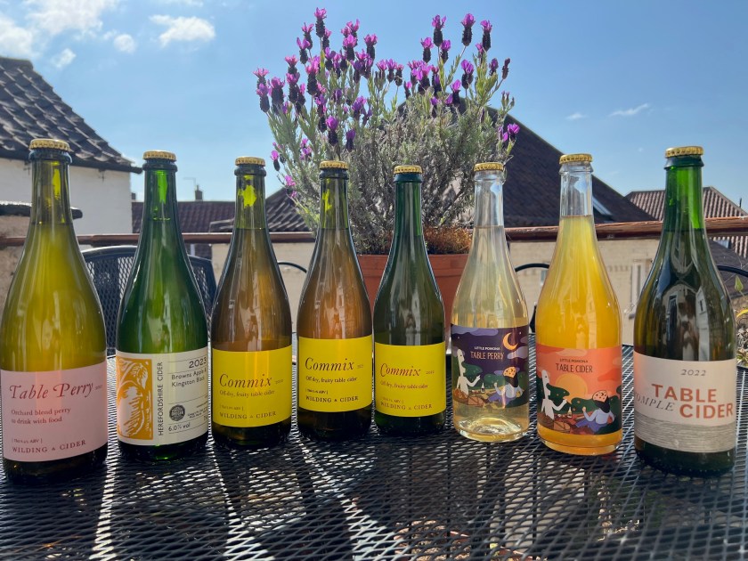 A collection of 8 Table Cider and Perry bottles on a balcony in the sunshine