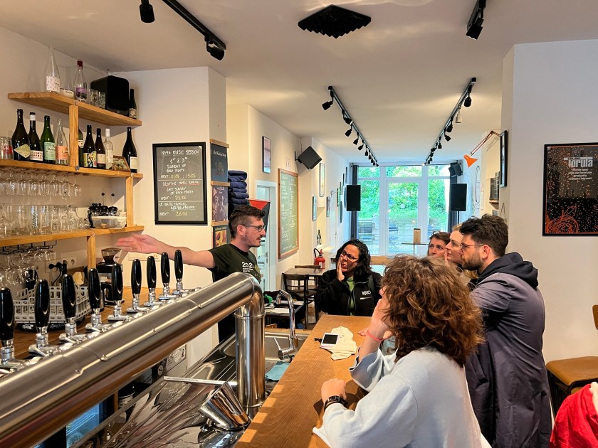 Joran shows his bar to an assembled group of local politicians
