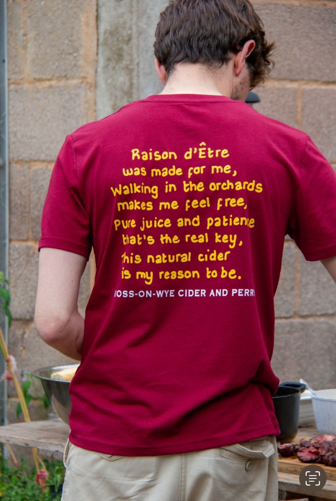 A photo showing showing the back of the new Raison d'Etre t-shirt, with a small poem/mission statement on it.