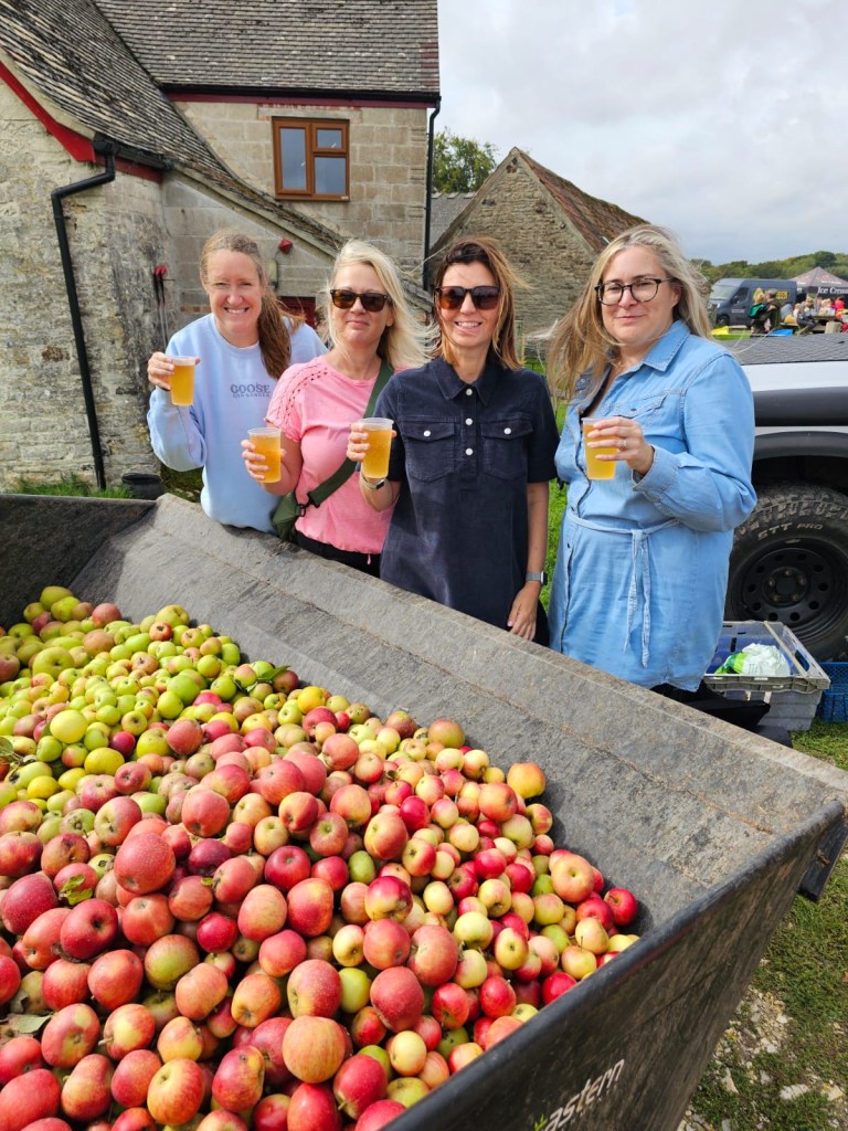 Team Purbeck in front of a lot of apples