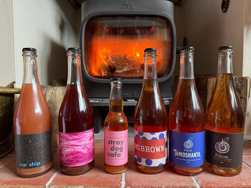 A collection of Pilton Cider bottlings in front of the stove