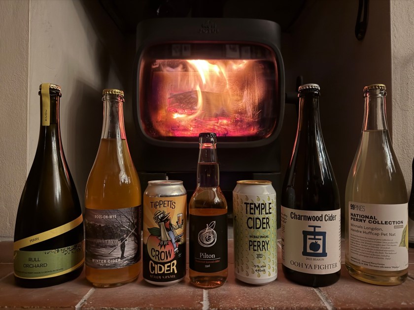 A selection of ciders and perries in front of the stove